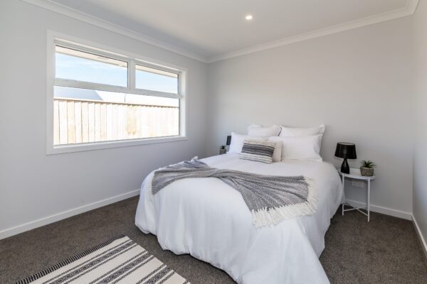 Completed bedroom in home construction by Frampton Construction West Melton